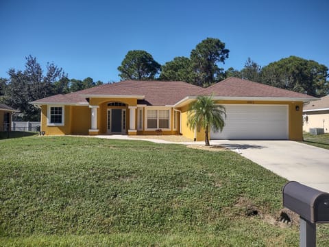 A street view of the property. There is a 2 car garage & parking on the driveway