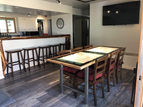Hand made table inlayed with maps of Zion 
Hand carved wood bar
55” TV