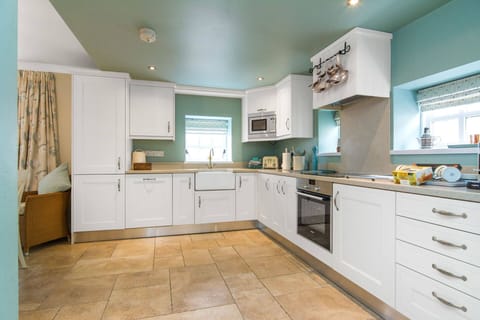 Spacious and well-equipped, the bespoke kitchen has cosy and smart country look.