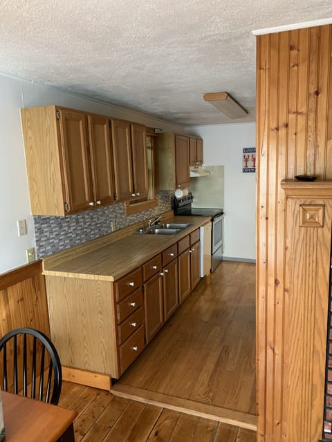 Kitchen area, w/ new stove, fridge, microwave, pans, pots, silverware, ext...