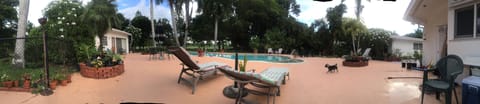 Outside space with chaise lounge chairs and umbrella tables w chairs