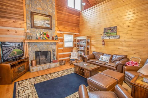 Living Room with Wood Burning Fire Place and Flat Screen TV