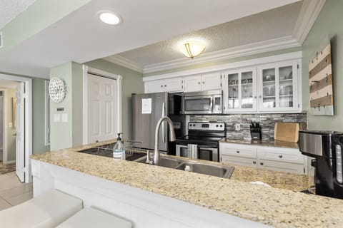 Open Kitchen that's been updated with granite and stainless steel appliances.