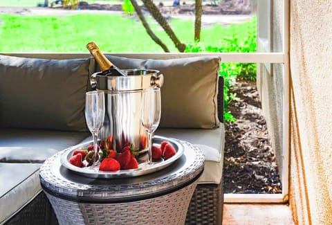 Outdoor Livingroom Patio with TV on wall and overlooking PGA Clubhouse and Learning Center
