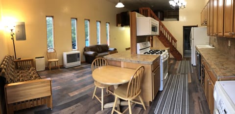 Living, dining, kitchen and loft also bathroom door in back ground 