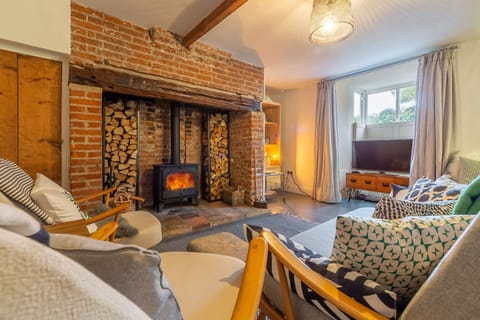 Willow Cottage, North Creake: Sitting room with large fireplace and wood burning stove