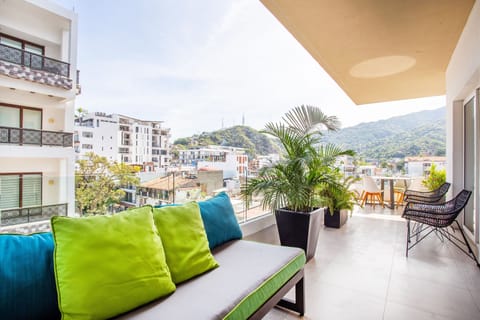The corner private balcony offers mountain and city views