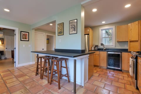 Kitchen opens into living room with #2 TV