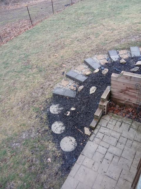 A few steps to get to the patio. Solar lights lighting the way