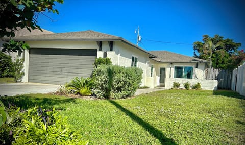 Front of House With 2 Car Garage and Courtyard Fire Pit Seating Area 