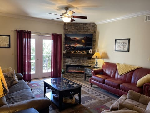 Living room with smart TV, Foosball Table and DVD player. 