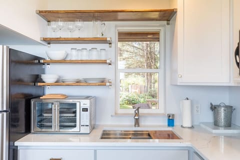 Quartz countertops, farm sink, griddle, crock pot, everything necessary to cook.