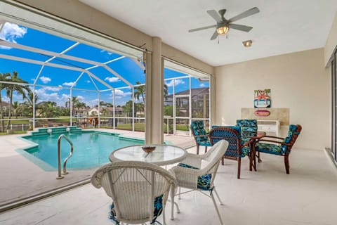 Enjoy your meals or morning coffee overlooking the pool and canal under the covered portion of the screened lanai.