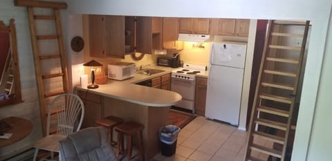 Kitchen area with loft stairs 