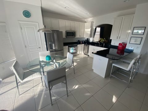 Fully equipped refurbished kitchen with breakfast bar and table