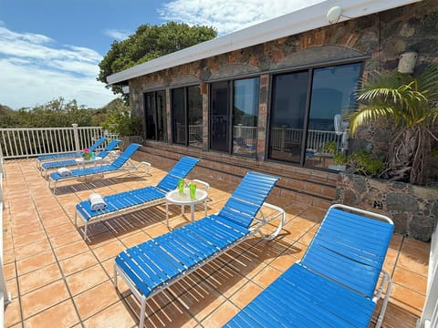 This sun deck is located off the living room.  The lounge chairs are calling your name.