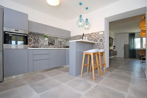 Fully equipped kitchen with dining area&exit to pool area + barbecue&Playground