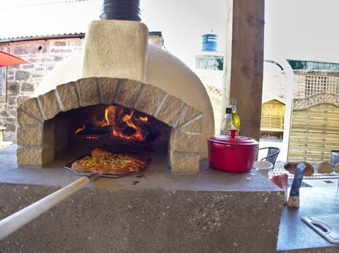 Wood fired pizza oven which is an experience cooking pizza, bread, veg or meat.