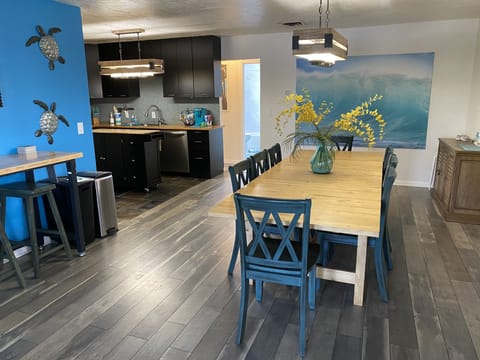 View into apartment. Large table w/ seating for 8 and tall table that seats 2