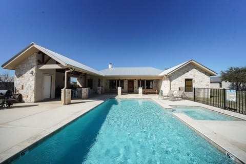 Back exterior view of house + swimming pool