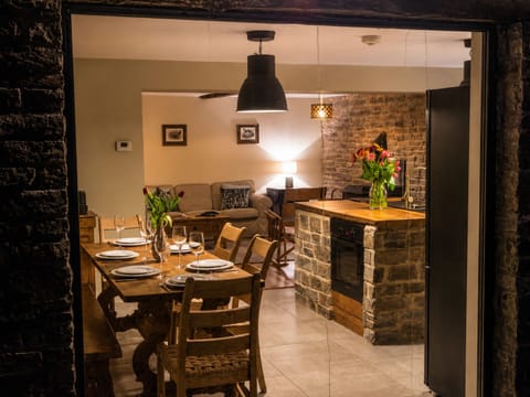 Rustic stone kitchen and dining space with cozy, inviting charm