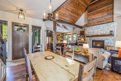 Modest wooden dining table that Seats Six with an aesthetically designed chandelier