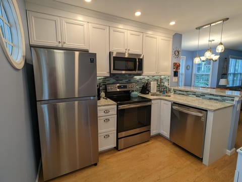 Newly renovated kitchen in 2022 with bright lighting for cooking.