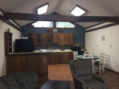 Standing in the living room which connects to the kitchen.