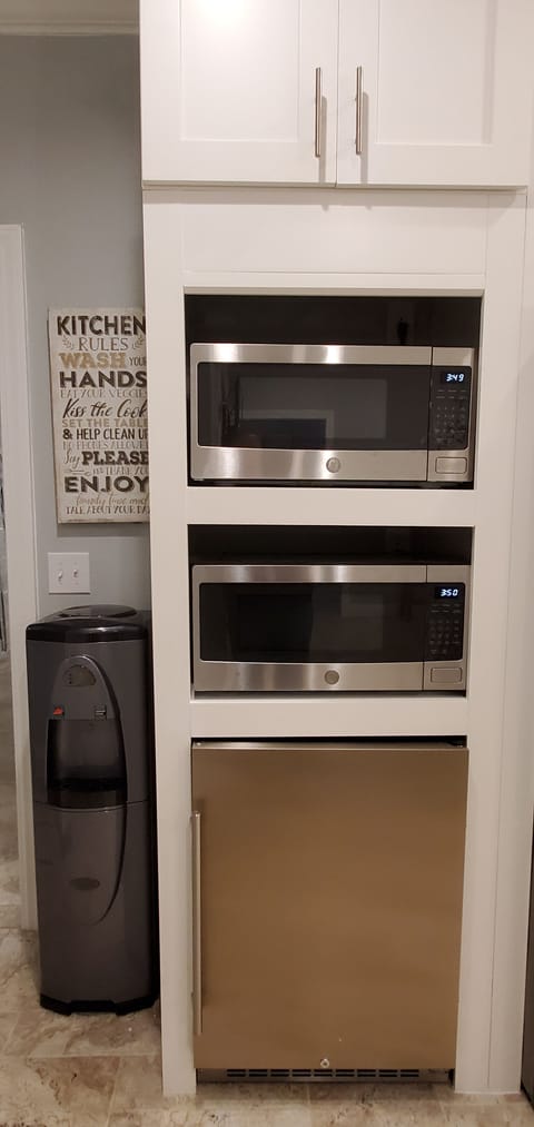 Two microwaves and mini fridge.