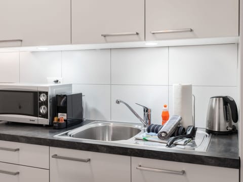 Tap, Kitchen Sink, Cabinetry, Sink, Countertop, Plumbing Fixture, Kitchen Stove, Kitchen, Interior Design, Kitchen Appliance