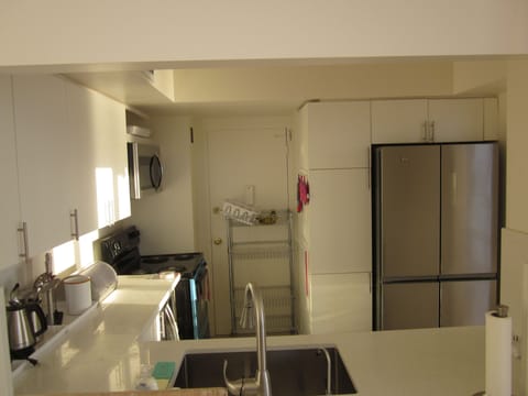Kitchen is well equipped and opens to the living room