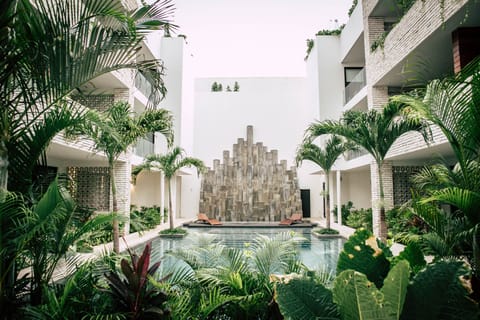 This boutique luxury condo boasts ad lush green courtyard with a large pool.