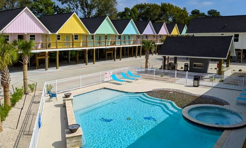 Main pool and hottub with view of the outdoor kitchen