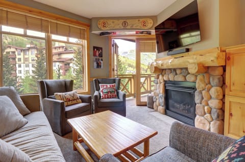 Cozy living room with private balcony access and fireplace.