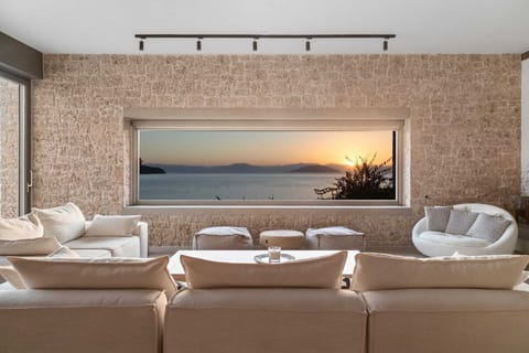 From the villa's living room, the sunset paints the sky in warm hues.