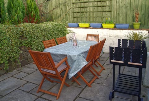Private patio area with dining table and BBQ