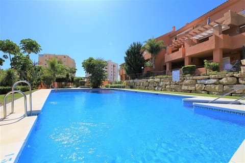 Inviting community swimming pool surrounded by lovely gardens