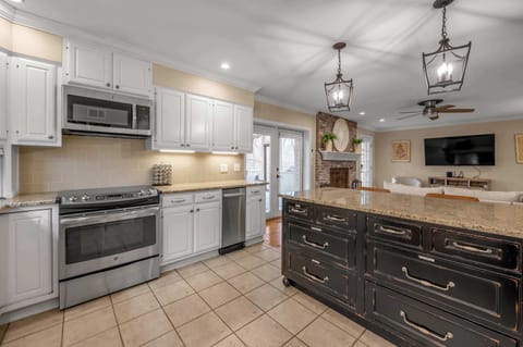 A fresh, well-organized kitchen showcasing updated appliances, under-cabinet lighting, and plenty of workspace.