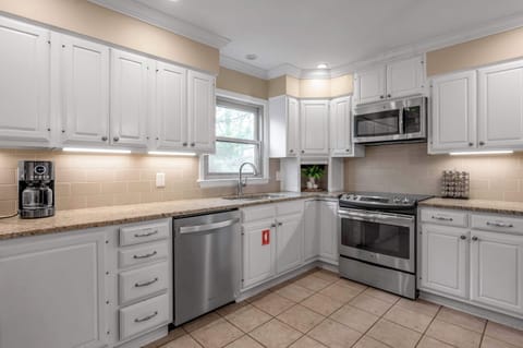 A bright culinary space featuring gleaming countertops, modern appliances, and generous storage, ideal for whipping up your favorite meals.