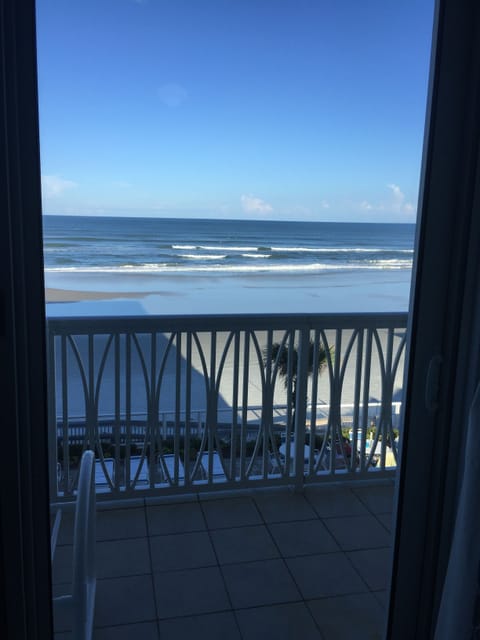 The porch offers lounge chairs and a table and chairs for reading or dining.