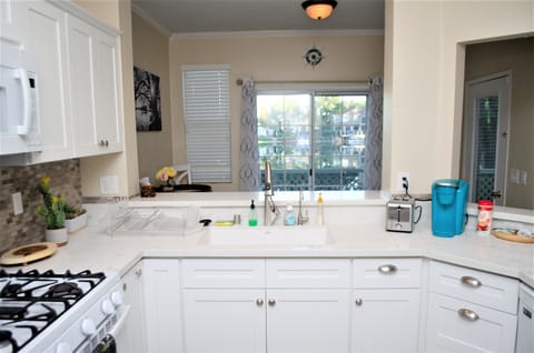 Kitchen is well equipped for cooking. Look for items in cabinets and drawers.