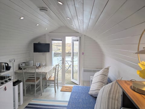 Bright living room/dining area with sofa bed and great view to the sea.