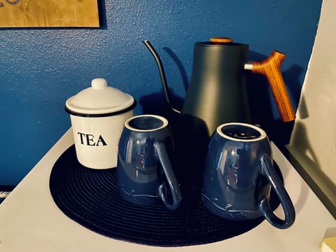 Tea bar ontop of the refrigerator. 