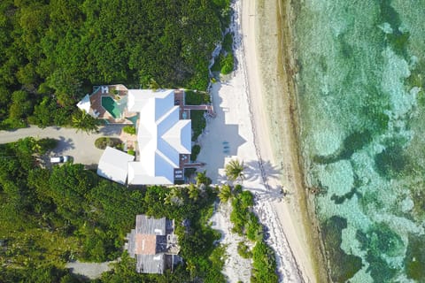 Aerial view of Hilltime's wide beachfront with backyard snorkeling. 
