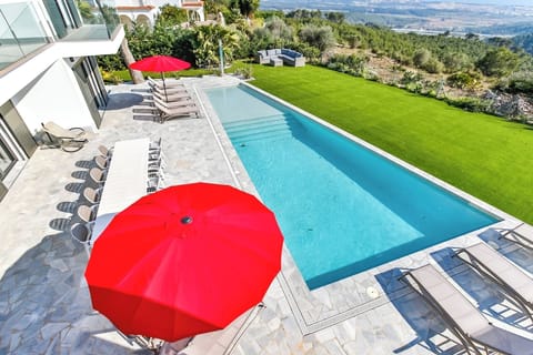 Fantastic turquoise coloured swimming pool with spectacular views over the surrounding countryside and out to the deep blue Mediterranean Sea.