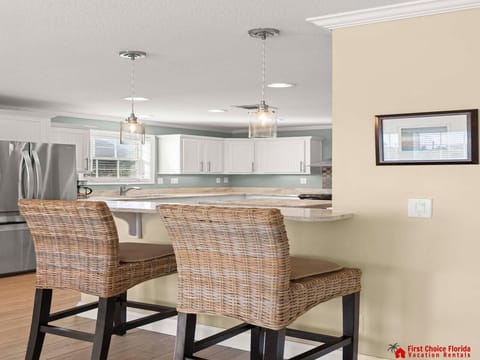 Bright, open kitchen with cozy breakfast bar seating