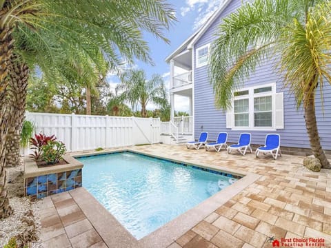 Private pool oasis with lush palm trees and sun loungers