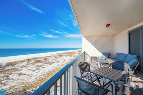 Relax on the balcony with comfortable seating, enjoying the expansive views of the tranquil waters and shoreline
