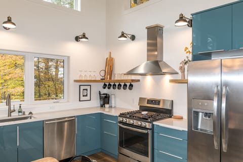 The kitchen includes brand-new appliances and cabinets stocked with dishes