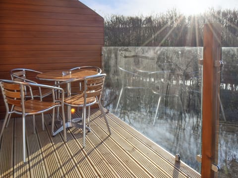 Decked patio with outdoor furniture | Waterside Lodge Sixteen - Ashgrove Country Park, Elland